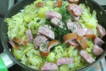 Капуста тушкована з кабачками та ковбасою. капуста