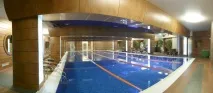 біля