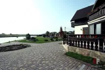 Двоповерховий дерев’яний будинок у баварському стилі з білою штукатуркою та темним деревом дерев