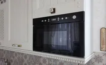 Вбудовувані чорні мікрохвильові печі в інтер’єрі кухні чорні