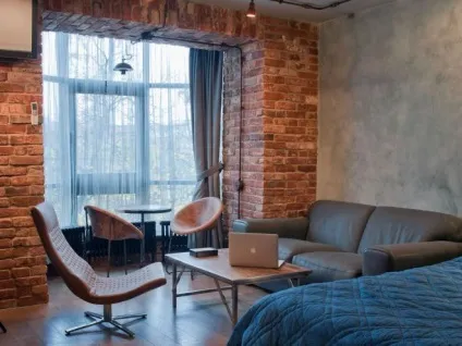 Маленька вітальня в квартирі з каміном