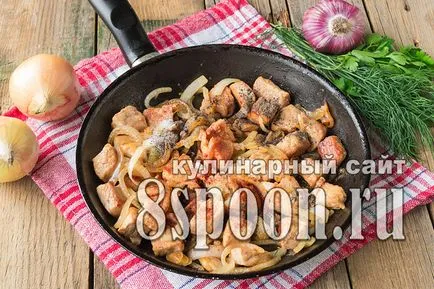 Sertés szelet sült egy serpenyőben egy íj (sült) Sertés sült egy serpenyőben szeletelt hagymát