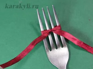 Egyszerű íjak szatén szalagokkal a villára, irkál